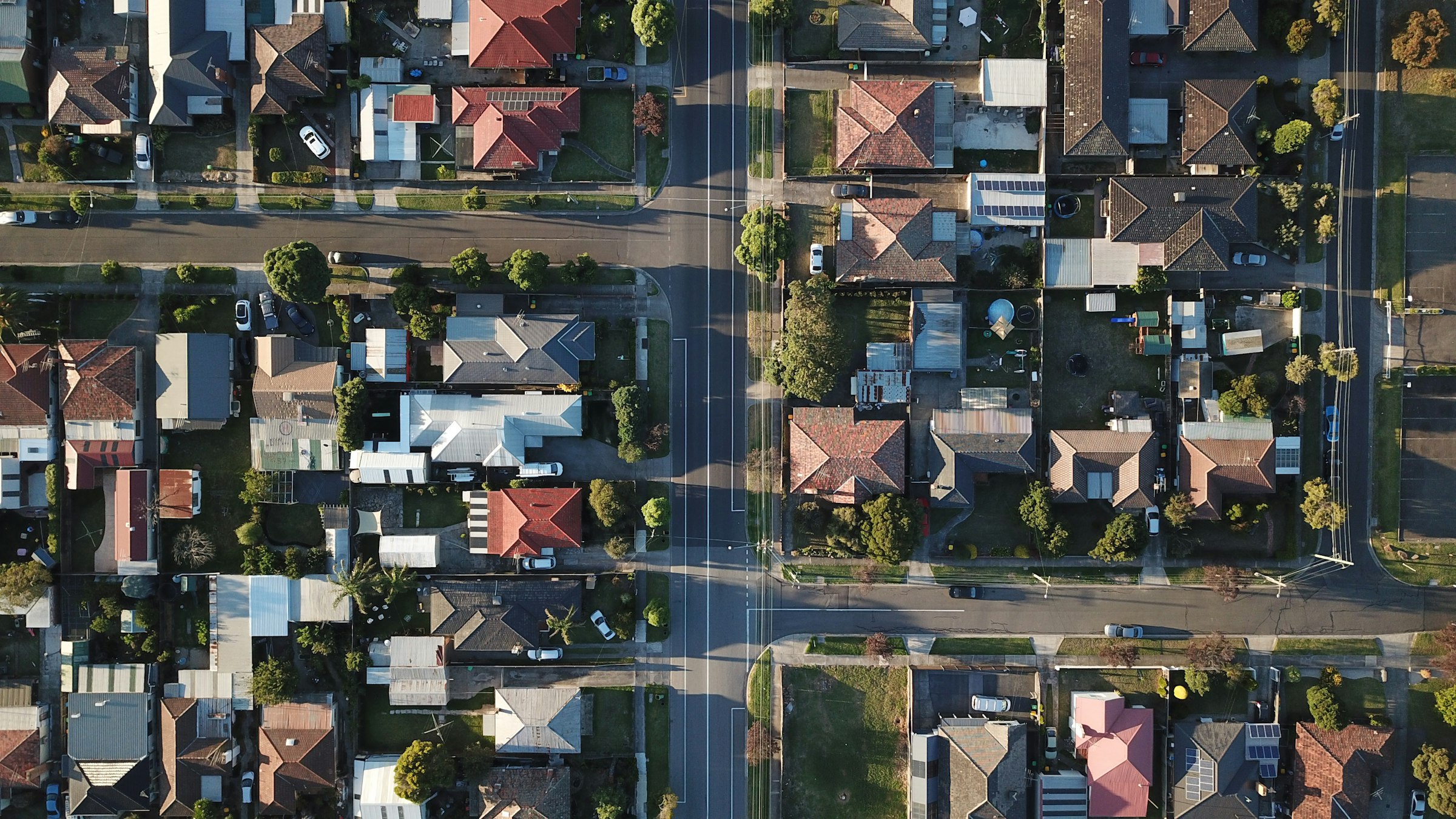 Aerial view of residential streets at dusk with long shadows